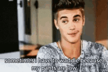 a young man is talking about his pants being low .