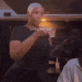 a man in a black shirt is standing in front of a mirror with the words livebitez on the bottom