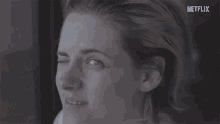 a close up of a woman 's face with the word netflix in the corner