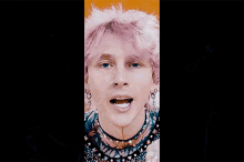 a close up of a man with pink hair and a nose ring
