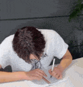 a man wearing a white shirt with the letter a on it