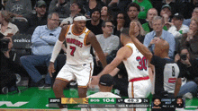 a warriors basketball player stands in front of a referee