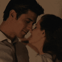 a man and a woman are kissing in the dark