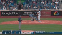 a baseball game is being played in front of an ad for google cloud