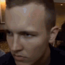 a close up of a man 's face looking at the camera