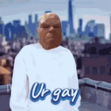 a man wearing a white shirt with the word ur gay on it