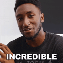 a man is wearing a black shirt that says incredible on it