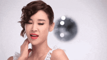 a woman with her eyes closed and red lipstick looks at the camera