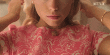 a close up of a woman 's face with netflix written on the bottom right