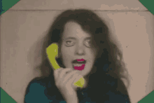 a woman with long hair and red lipstick is making a funny face with her eyes closed .