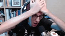 a man wearing glasses and a black shirt that says ' i 'm a fool ' on it
