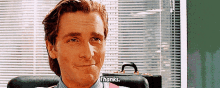 a man sitting in a chair with a briefcase says thanks