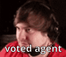 a man wearing headphones with the words `` voted agent '' on his face .