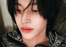 a close up of a person 's face with black hair and red lips