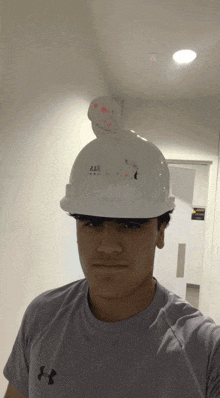 a man wearing a hard hat that has the number 212 on it