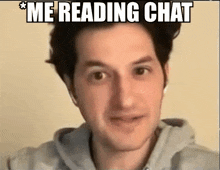 a man wearing headphones looks at the camera with the caption " me reading chat "