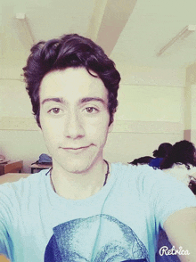 a young man in a blue shirt is taking a selfie with retrica app