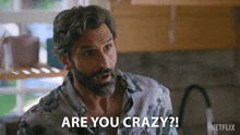 a man with a beard says " are you crazy " in a kitchen