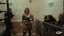 a female wrestler is standing in front of a fence with a caption that says cap on it