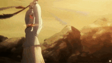 a woman in a white dress is holding a sword over her head in a field .