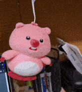 a pink stuffed animal is sitting on a desk next to a box that says casio