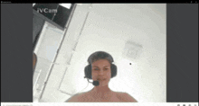 a man wearing headphones and a microphone on a video call