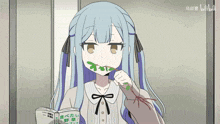 a girl with blue hair is reading a book and eating a green leaf