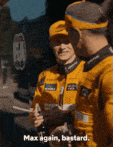 a man wearing a monster energy hat stands next to another man