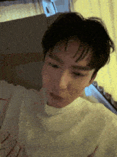 a close up of a person 's face with a white shirt that has the letter z on it