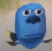a blue cartoon fish with big eyes and a big nose is looking at the camera .