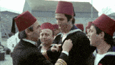a group of men wearing red hats are standing in a line