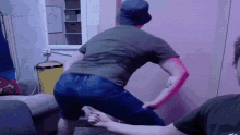 a man wearing a hat and a green shirt is dancing in a room