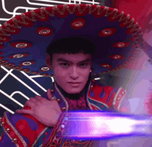 a man wearing a sombrero and a red and blue jacket
