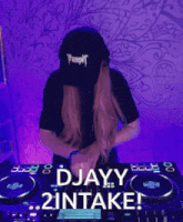 a woman wearing a trumpet hat is behind a dj mixer