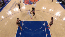 a basketball game is being played on a court sponsored by msq