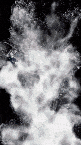a black and white image of water splashing against a dark background