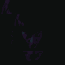 a close up of a woman 's face in the dark with red and blue lights behind her