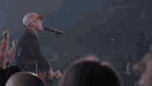 a group of people standing on stage with their hands in the air