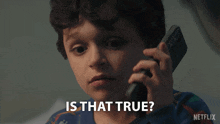 a young boy is talking on a cell phone and the caption says is that true