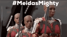 a group of women are standing next to each other holding swords in a line .