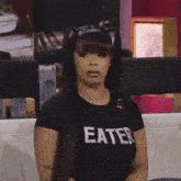 a woman is wearing a black shirt that says eater on it
