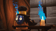 a lego figure with a blue shield on his back is standing next to a candle