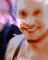 a blurry picture of a woman 's face with a purple background