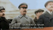 a man stands in front of a sign that says " the heart 's uneasy in the chest .. "