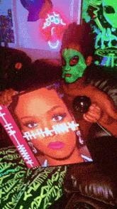 a man wearing a green mask is holding a magazine that says " rihanna "