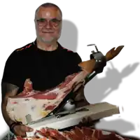 a man holds a large piece of meat in his hands