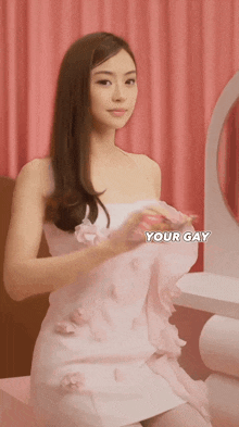 a woman in a white dress is sitting in front of a mirror with the words your gay written on the bottom