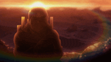 a silhouette of a man in a chair with the sun behind him