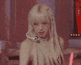 a blonde woman with a microphone on her head