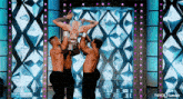 a group of men are holding a woman up in the air on a stage with the words tayce tumblr below them